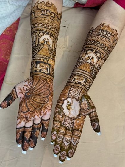 A full view of the matching bridal arms, with palace architecture and peacocks creating a symmetrical and royal look.