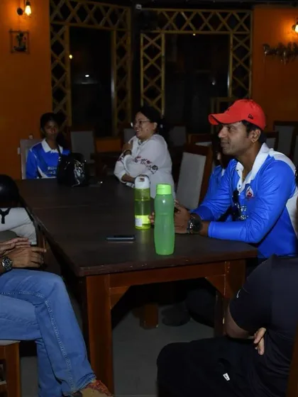 A coach debriefing with the team. Communication and strategy are key components of our training, especially during competitions.