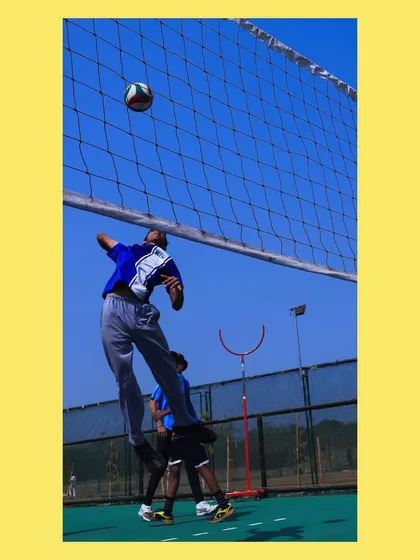 A player jumping high for a spike, showing the vertical leap we work to develop.