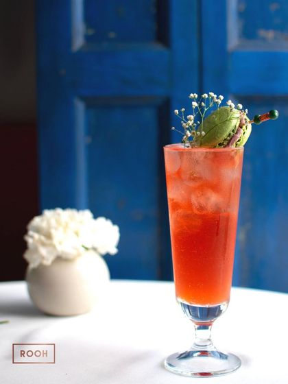 A beautiful cocktail against our signature blue doors. The colours pop, making the drink even more inviting.