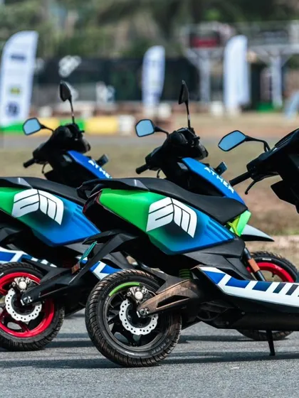 A lineup of race-prepped Ather electric scooters, showcasing the branding for the Evotron motorsports event.