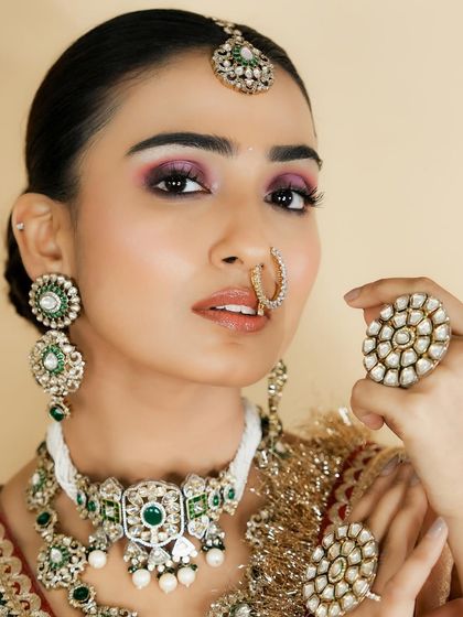 This pose, highlighting the ring, is common in bridal photography. You will learn makeup techniques that ensure your client looks stunning in all their photos.