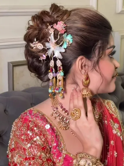 A side profile showcasing a unique and modern hair accessory paired with a traditional bridal bun. I love adding personal touches to make each bridal look unique.