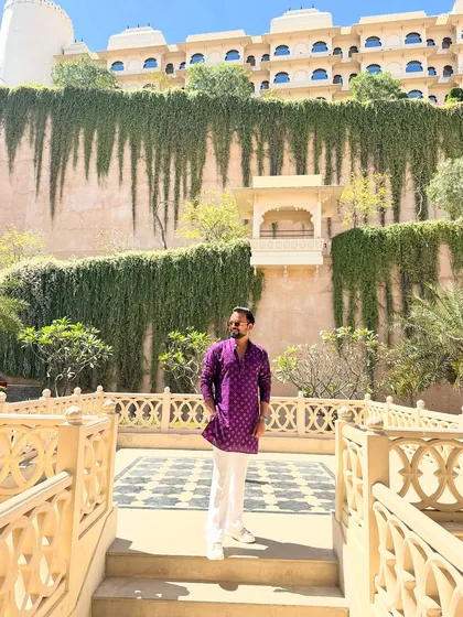 Dressed in a purple kurta that complements the royal vibe of Udaipur. Ready to host a spectacular Nepali wedding.