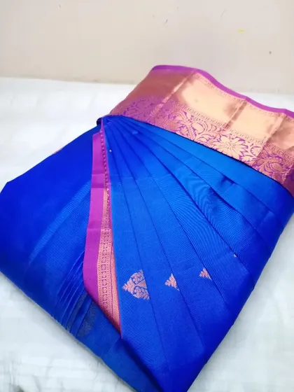 A striking royal blue silk saree with a pink border.