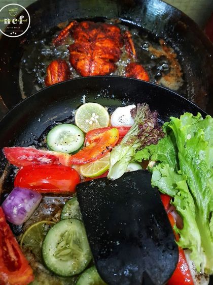 Frying a whole chicken while preparing a fresh salad on the side. This shows how I cook everything fresh for my customers.