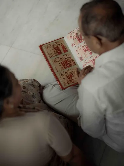 An over the shoulder view as they look through their wedding album, a collection of memories that started their family. It’s a powerful reminder that every great love story has a beautiful beginning.