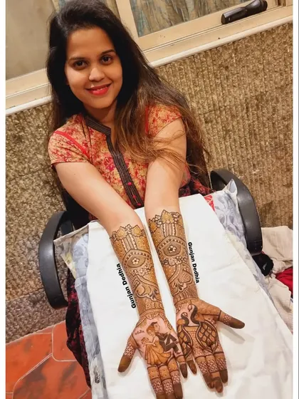 My lovely client Ravina, all smiles with her full engagement mehendi. The design features a couple portrait and beautiful peacock motifs.
