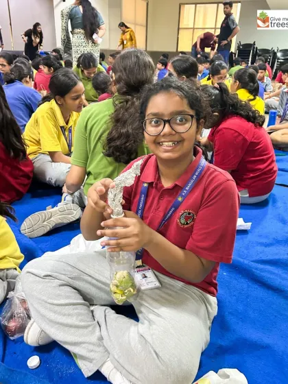 The joy of discovery on a student's face as she works on her bio-enzyme mixture. These workshops are designed to be as fun as they are educational.