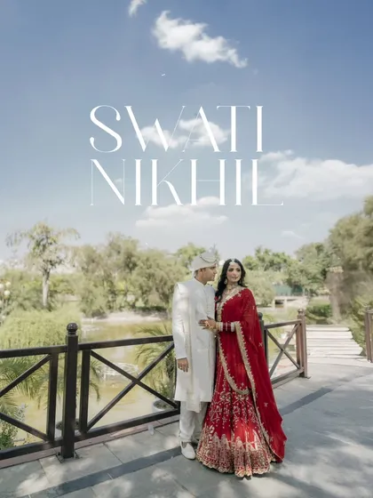 A grand, poster-like portrait of the couple on a bridge, with the sky and landscape creating a beautiful backdrop for their wedding day.