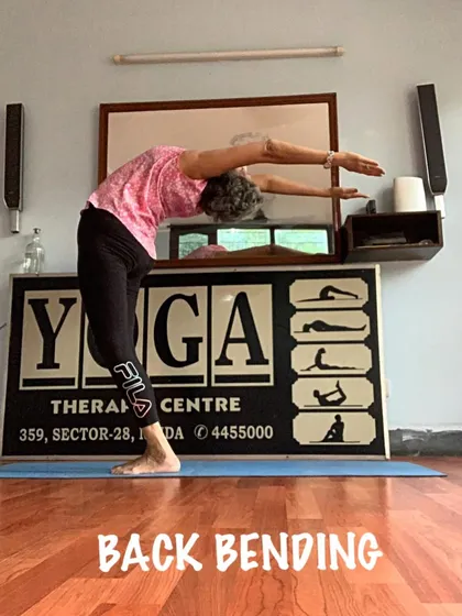 A standing backbend, showing the arms reaching up and back to create a beautiful arch.