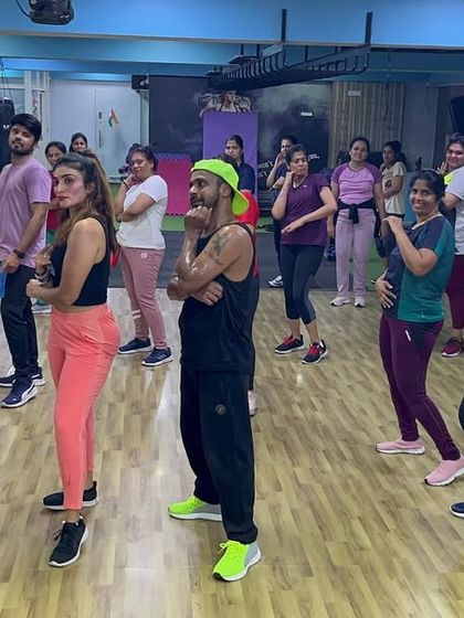 The class follows the instructor's lead, learning a new piece of choreography together.