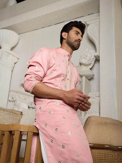 This pink ethnic kurta is a standout piece that exudes confidence and style, perfect for reflecting your individuality with flair.