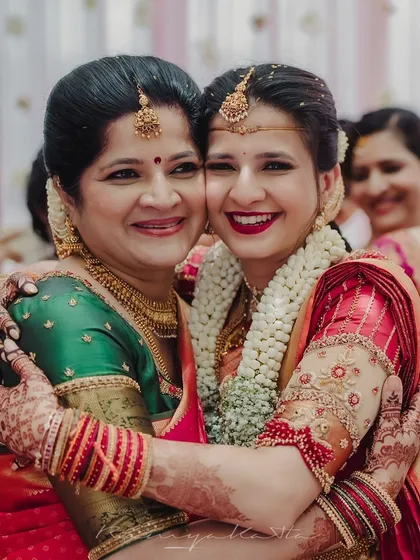 A beautiful moment between a bride and her mother, both adorned in my custom creations. I specialize in designing coordinated outfits that celebrate family bonds and create harmonious visual stories for your wedding day.