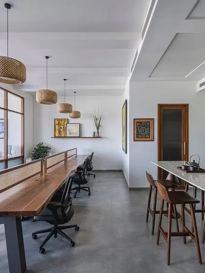 A wide shot of the 'Sepalika' office, showcasing the blend of a communal workstation with a more relaxed lounge area, creating a versatile and welcoming workspace.