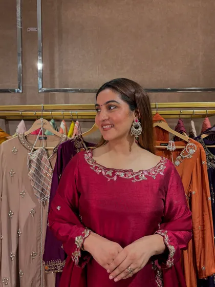 A smiling shot in the wine-colored suit. The color is universally flattering and perfect for the festive season.