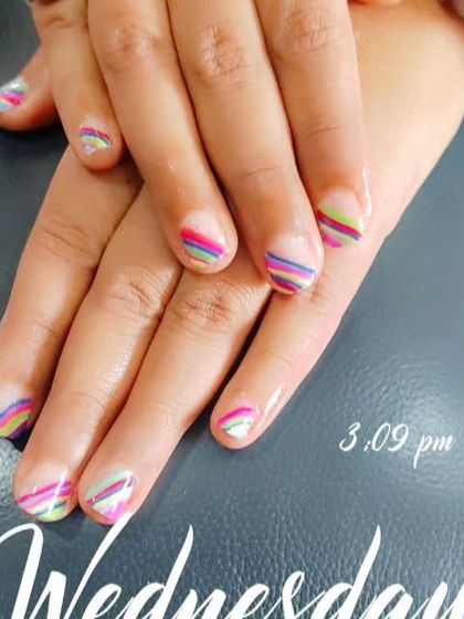 Another look at the fun and colorful striped nail art, showing the precision of the thin lines.