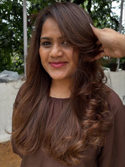 A beautiful color refresh for this client, getting her vacay-ready. I added soft, natural-looking highlights to her long hair and finished with a layered cut and bouncy curls for a glamorous feel.