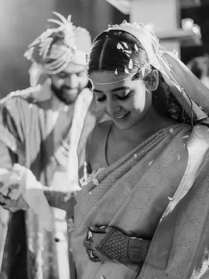 A beautiful black and white photo of the bride blushing during her pheras. It's a quiet, intimate moment that speaks volumes.