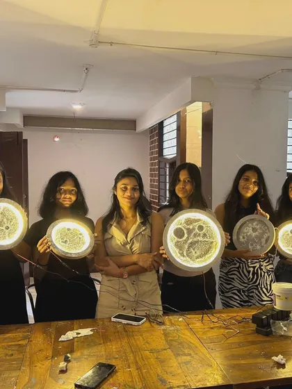 A group of proud students showcasing the beautiful moon lamps they created during a workshop at the café. It’s always rewarding to see their happy faces and glowing artwork.