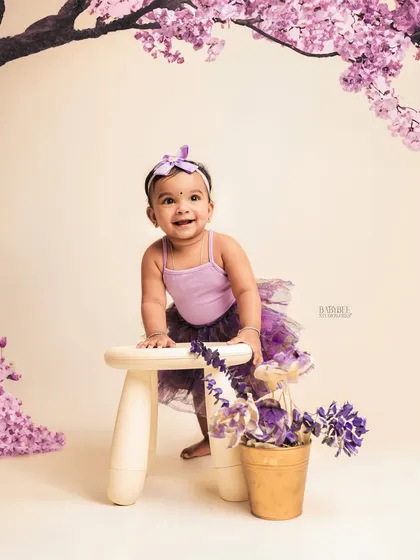We blend photography with a touch of digital magic. This portrait started in our studio and was transformed with AI to place this little girl under a beautiful canopy of cherry blossoms.