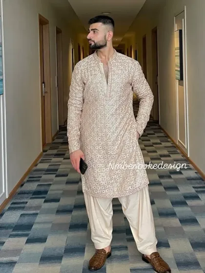 The client looking stylish in the beige mirror-work kurta.