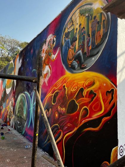 A side view of the IIT Bombay mural, showing its length and the narrative flow from one end to the other. The wall tells a story that unfolds as you walk past it.