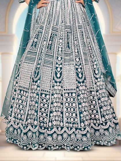 A detailed shot of the skirt of the bottle green lehenga, showing the quality of the embroidery.