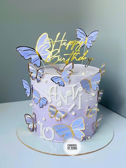 An elegant lavender ombre cake decorated with beautiful purple and gold butterflies for a 10th birthday.