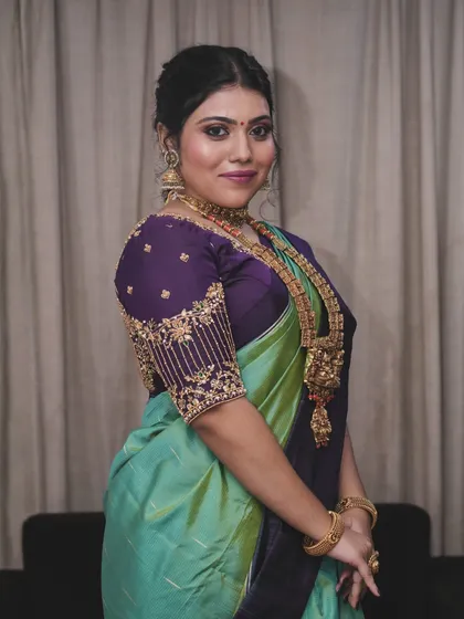A classic portrait pose. The soft glam makeup enhances her features, giving her a polished and elegant look for her special occasion.