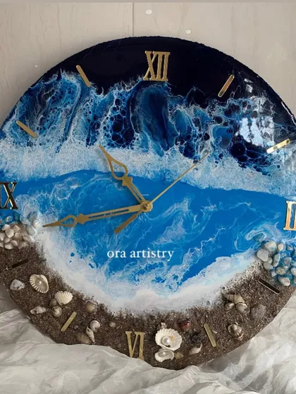 A dramatic ocean clock with deep blue water and crashing white waves. The beach is made with real sand and a variety of shells.