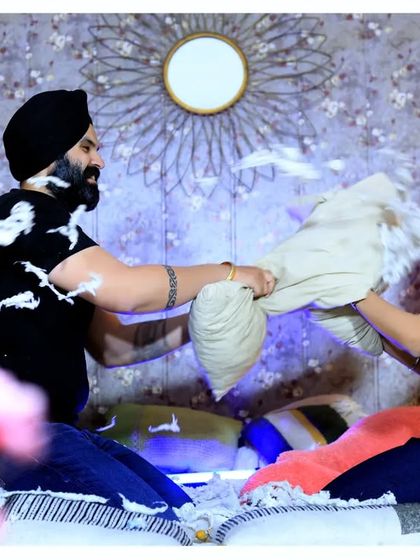 A playful pillow fight during a pre-wedding shoot. This is a great way to capture a couple's fun-loving side and create some genuinely happy and candid moments.