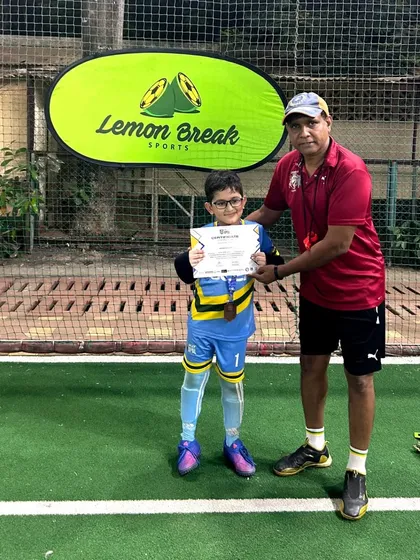 One of our coaches felicitating a young goalkeeper for his excellent performance in the U-9 league. We nurture talent in every position on the field.