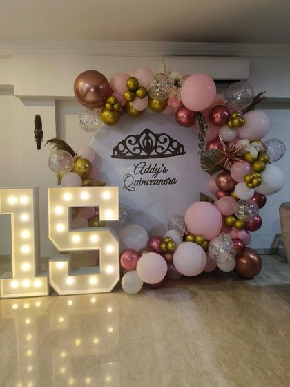 Another angle of the elegant Quinceañera decor, showing the detail in the balloon arrangement.
