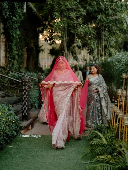 The bride's entrance is a pivotal moment. I ensure the pathway is just as beautiful as the destination, with a clean green aisle flanked by candle stands and foliage, leading to the mandap.