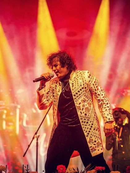 Our lead vocalist, commanding the stage with his powerful presence and soulful voice.