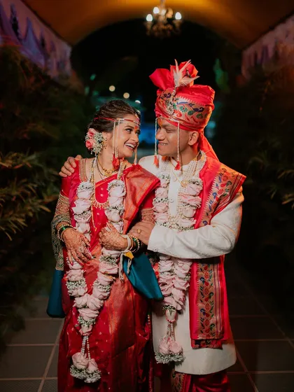 A happy portrait of the couple in a tunnel, smiling at each other after their wedding ceremony.