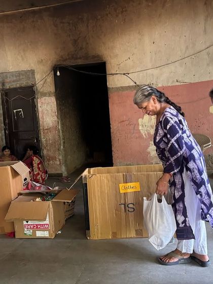 Community members work together to organize and pack dry waste into boxes during a residential collection drive. This collaborative spirit is at the heart of what we do.