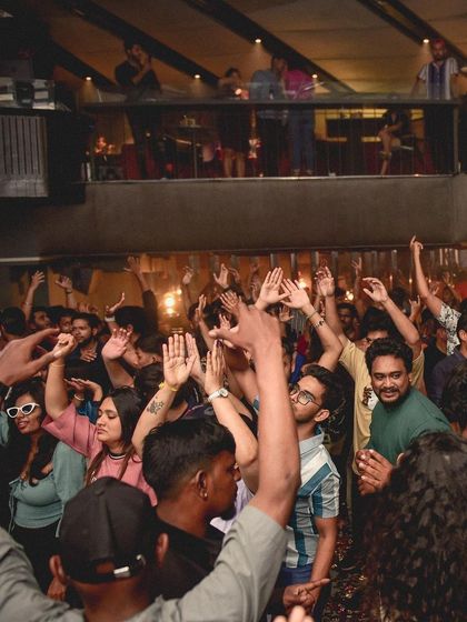 The crowd with their hands up, a classic sign of a great party.