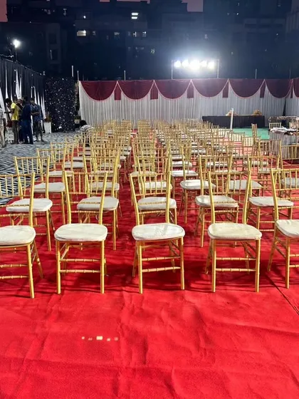We arranged the seating for a large outdoor corporate event on a plush red carpet. This image shows the scale of our operations, ensuring every guest has a comfortable seat for the main function.