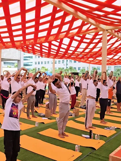 Participants enjoying a side stretch during a large outdoor corporate event. These simple movements help release tension in the sides of the body and improve flexibility.