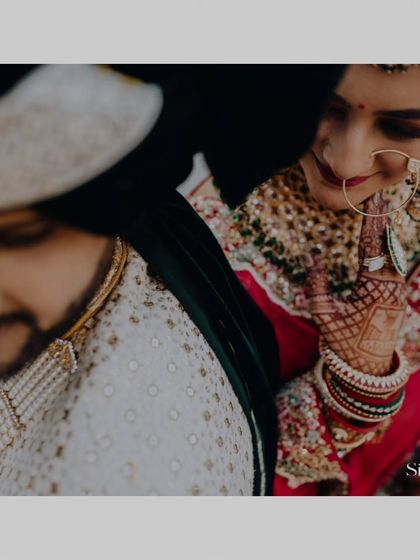 An intimate, artistic close-up of the couple, focusing on the bride's nose ring and the gentle connection between them.
