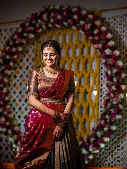 A beautiful, candid moment from Niveditha's ring ceremony. Her traditional half-saree and soft makeup create a look of timeless elegance against the festive backdrop.