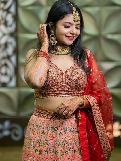 A beautiful bridesmaid look for her sister's wedding, featuring a gorgeous lehenga and bold red lips.