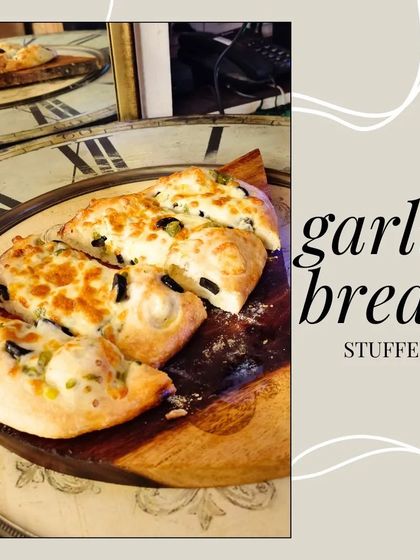Our stuffed garlic bread is a must-try appetizer. Warm, soft bread is filled with cheese, olives, and herbs, making it the perfect start to your meal.