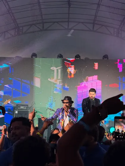 On stage during our first show in Singapore. The production was massive, with a huge LED screen and amazing lights, creating a full concert atmosphere for the corporate audience.