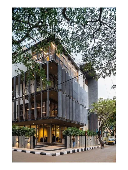 The Slate House, my studio, is designed to coexist with its urban, natural environment. Ultra-high-performance concrete fins create a rhythmic facade, providing shade to staggered balconies that offer views of the adjacent rain trees. The building engages in a direct dialogue with the street and the sky.