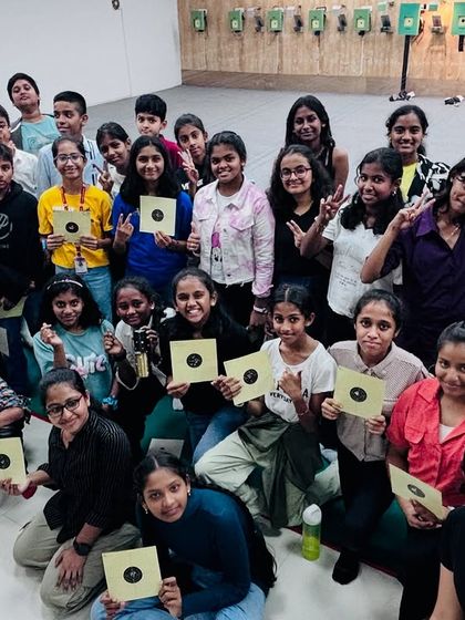 A happy group of shooters from Carmel Academy holding up their targets after a fun and productive Children's Day session.