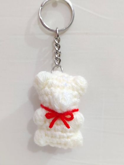 Cute and chewy-looking gummy bear keychains with little bows, available in white, brown, and lavender.