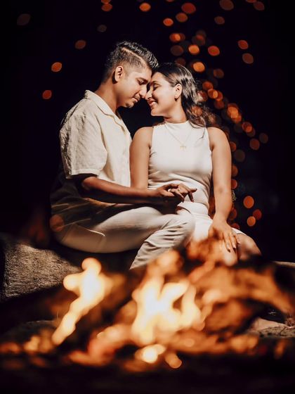 Eden and Snyder sharing a smile by the bonfire. The fire provides a warm, dynamic light source that makes for truly unique and romantic night portraits.